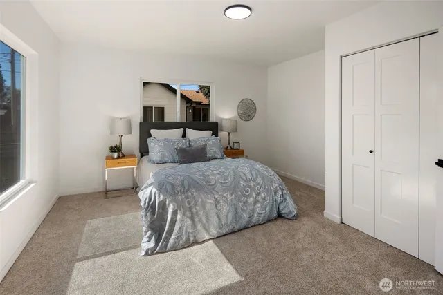 a bedroom with a large bed and a large window