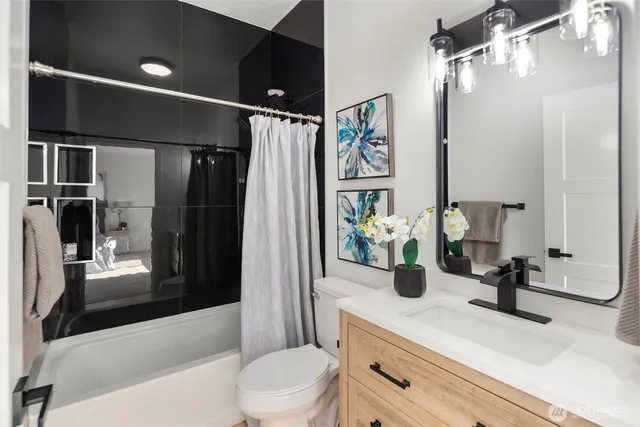 a bed room with a bed and a painting on the wall