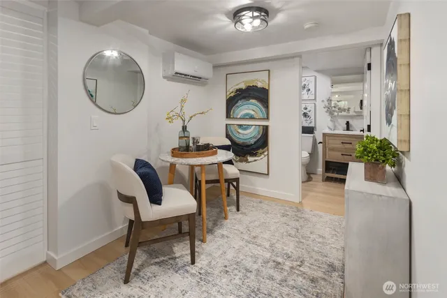 a living room with furniture potted plant and kitchen view