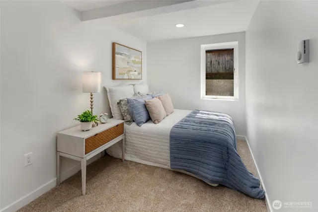 a bedroom with a bed and a painting on the wall