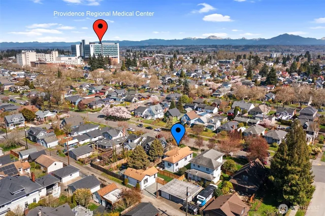 a front view of a house with a garden and yard