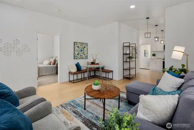 a kitchen with stainless steel appliances a refrigerator sink and wooden floor