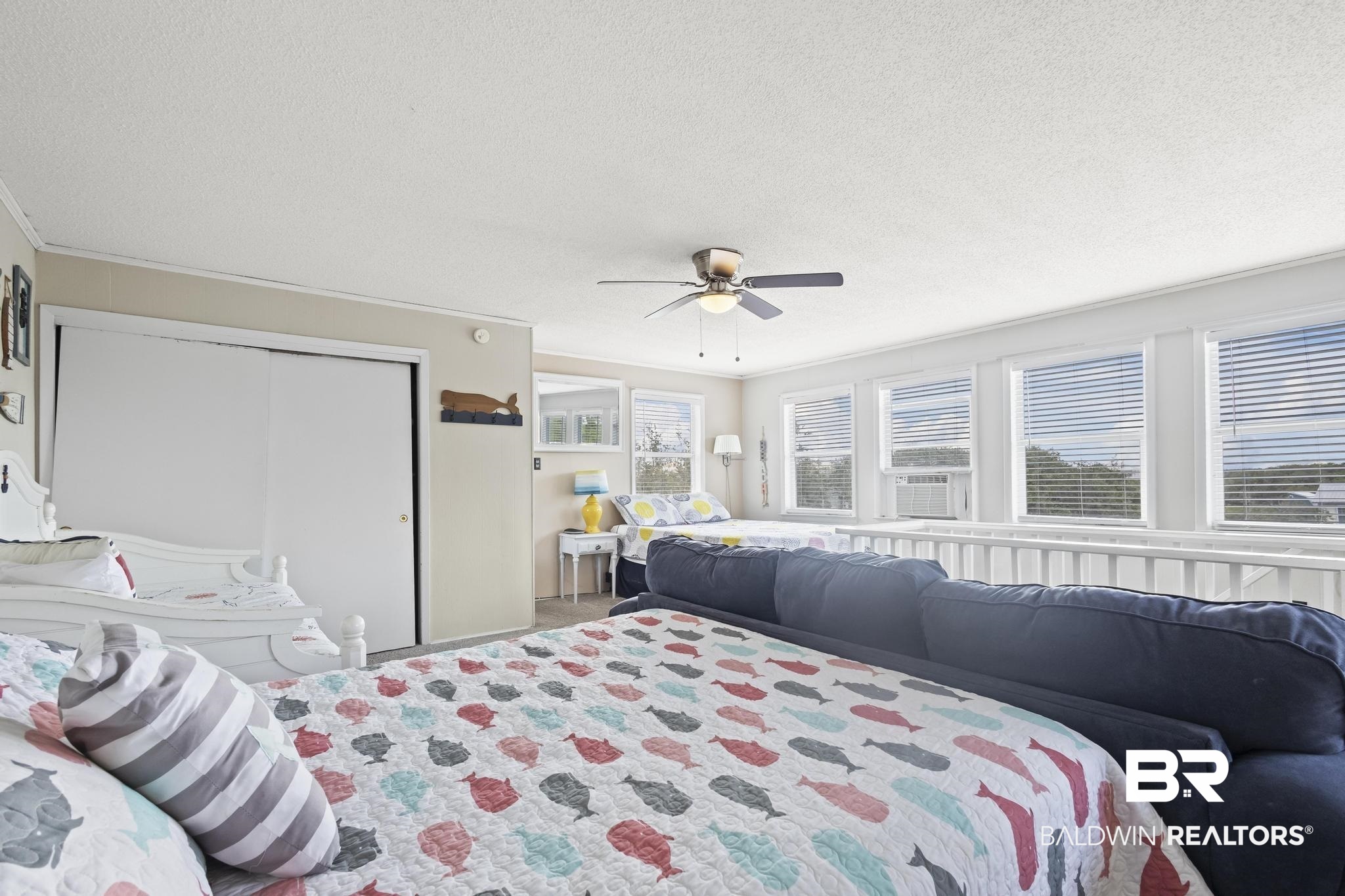 562 Veterans Road Gulf Shores, AL 36542 - Photo 23 of 32 Bedroom with a textured ceiling, a closet, ceiling fan, carpet, and cooling unit