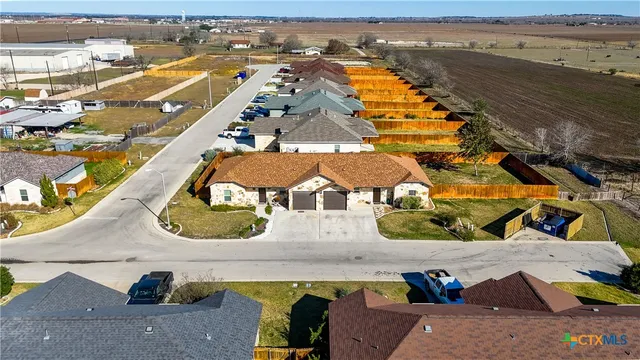 an aerial view of residential houses with outdoor space