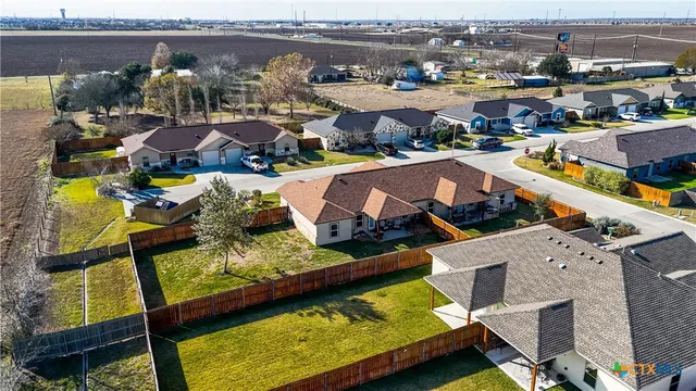 an aerial view of residential houses with outdoor space