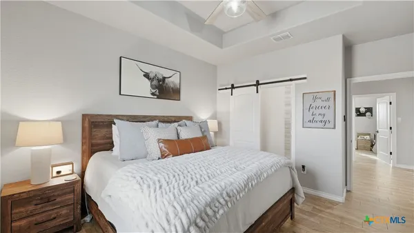 a bedroom with a bed and wooden floor