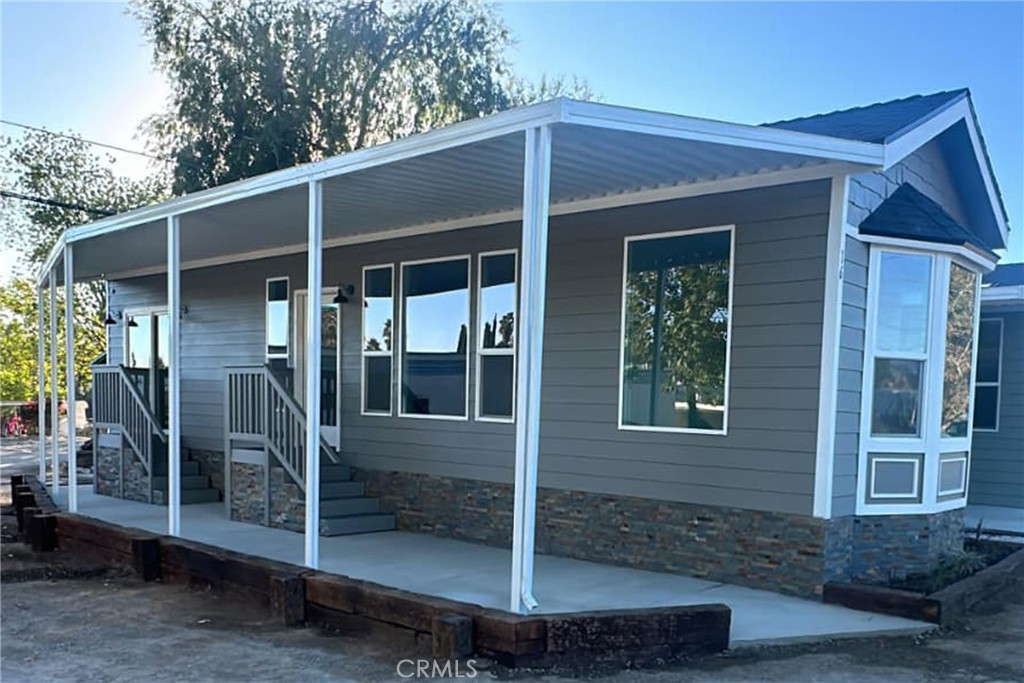22113 Grand Terrace Road, Unit 16 Grand Terrace, CA 92313 - Photo 1 of 15 a front view of a house with glass windows and yard