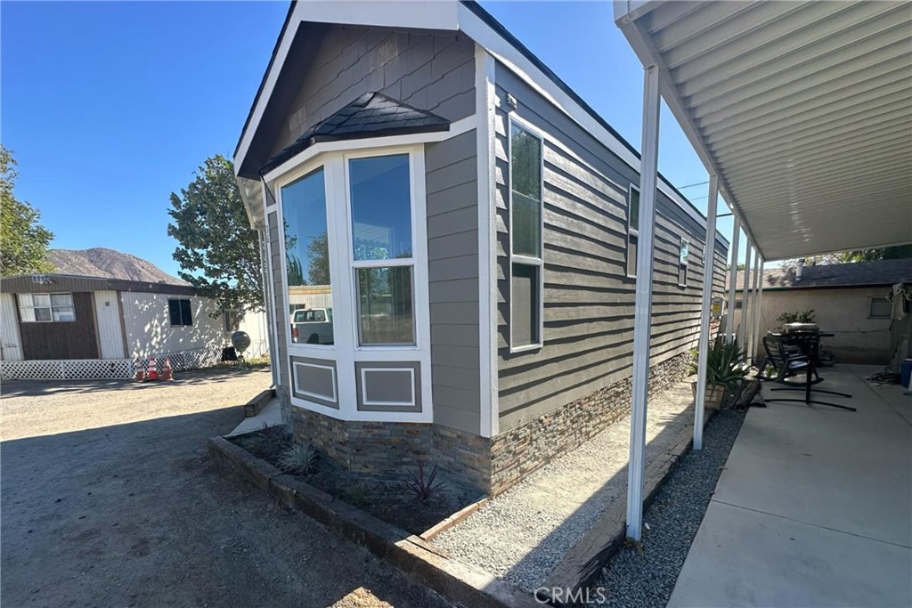 22113 Grand Terrace Road, Unit 16 Grand Terrace, CA 92313 - Photo 3 of 15 a front view of a house with a yard