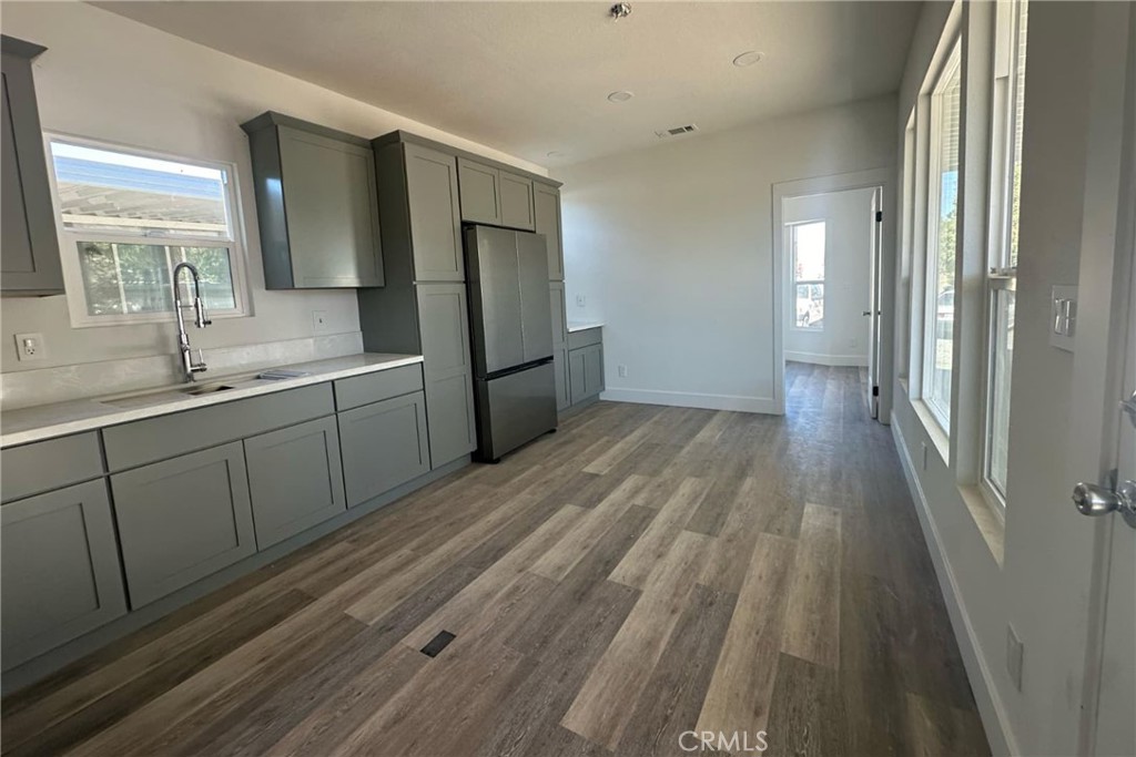 22113 Grand Terrace Road, Unit 16 Grand Terrace, CA 92313 - Photo 6 of 15 a kitchen with stainless steel appliances a sink cabinets and wooden floor