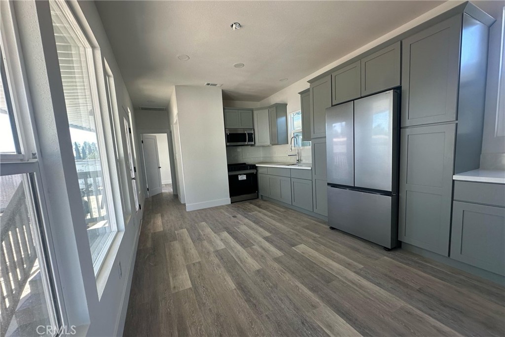 22113 Grand Terrace Road, Unit 16 Grand Terrace, CA 92313 - Photo 7 of 15 a kitchen with stainless steel appliances granite countertop a refrigerator and a sink