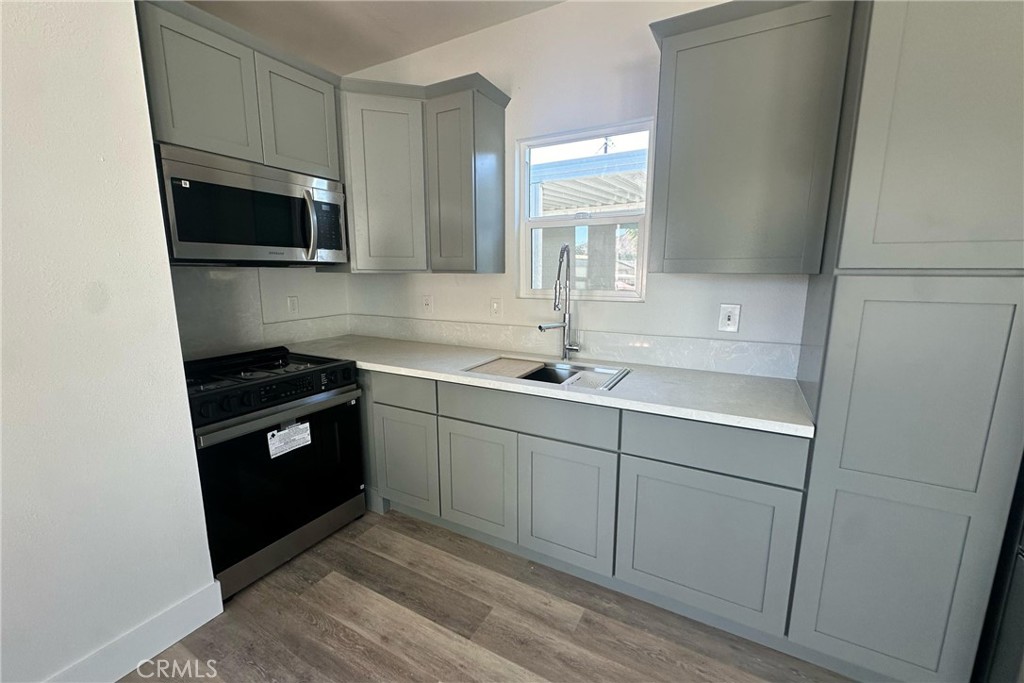 22113 Grand Terrace Road, Unit 16 Grand Terrace, CA 92313 - Photo 8 of 15 a kitchen with a sink and a stove top oven