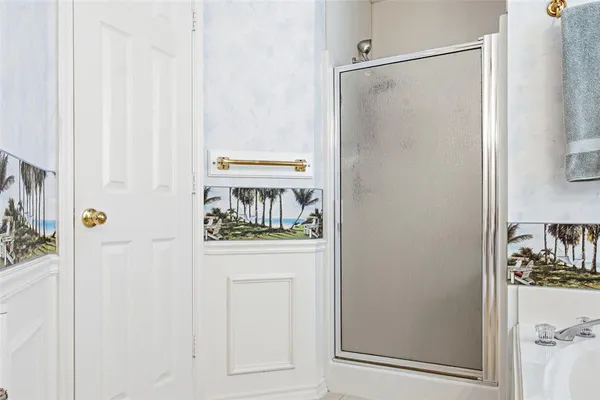 a bedroom with a bed table chair and a window