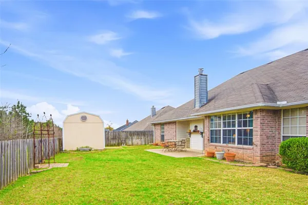 a view of a house with backyard and sitting area
