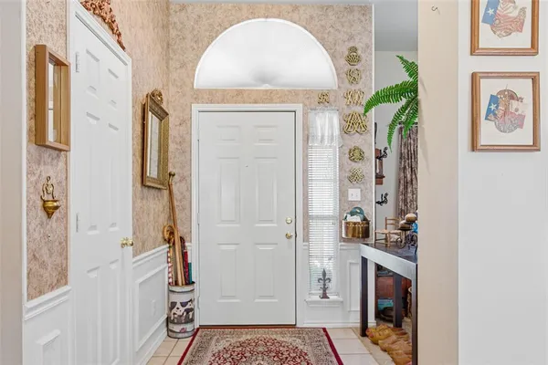 a living room with furniture fireplace and a large window