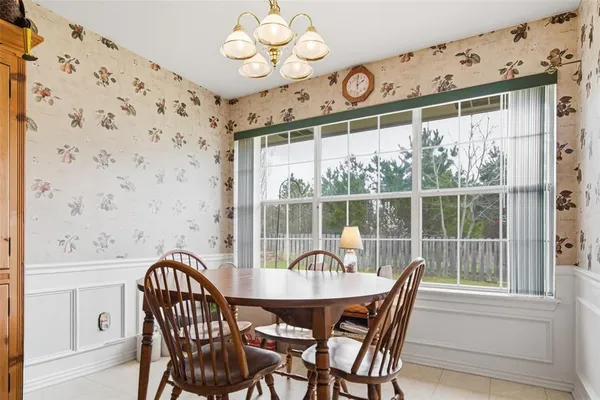 a view of a dining room with furniture and a chandelier