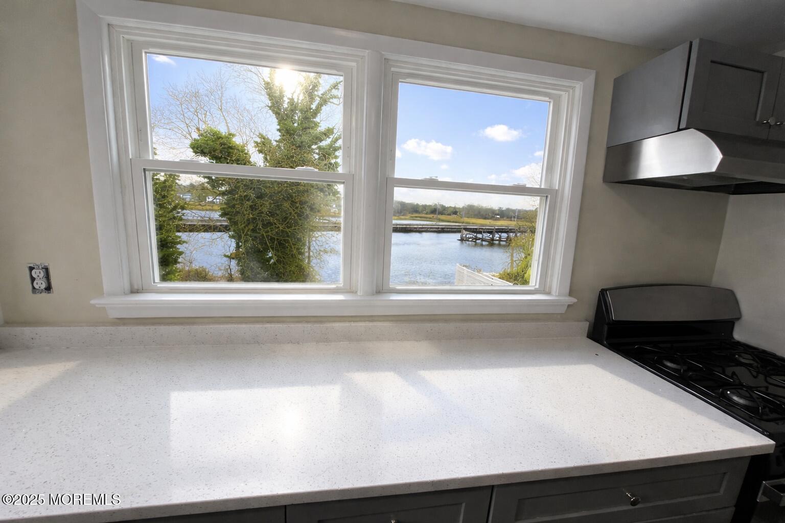 a bathroom with a sink and a large window