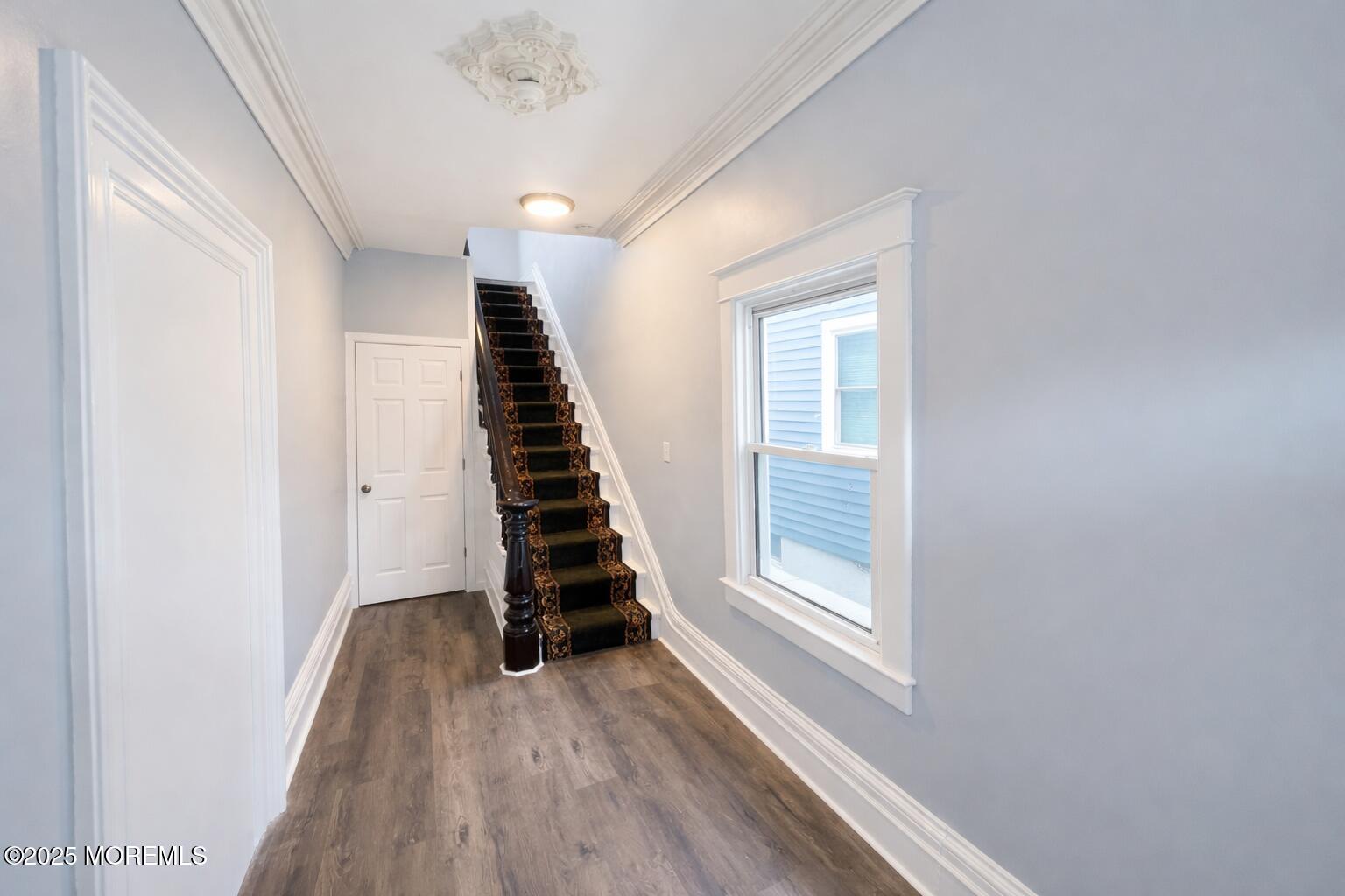 a view of room with stairs and wooden floor