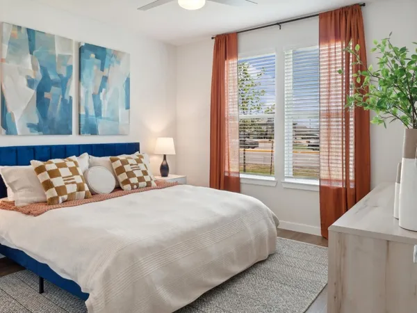 a bedroom with a large bed and a large window