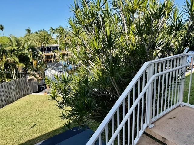 301 East McNab Road, Unit 205 Pompano Beach, FL 33060 - Photo 19 of 22 a view of balcony with wooden floor and fence