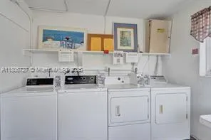 a utility room with sink washer and dryer