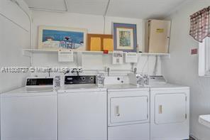 301 East McNab Road, Unit 205 Pompano Beach, FL 33060 - Photo 21 of 22 a utility room with sink washer and dryer