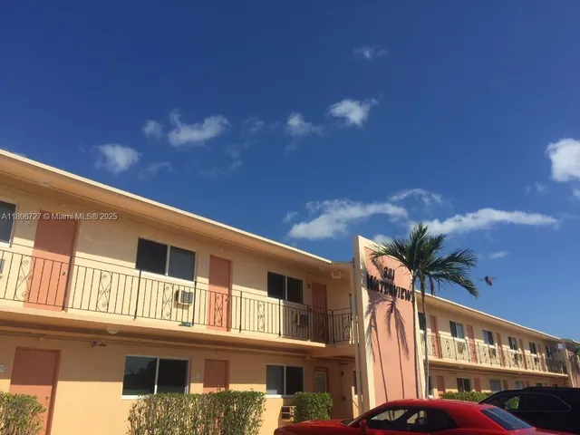 a front view of a building with a yard