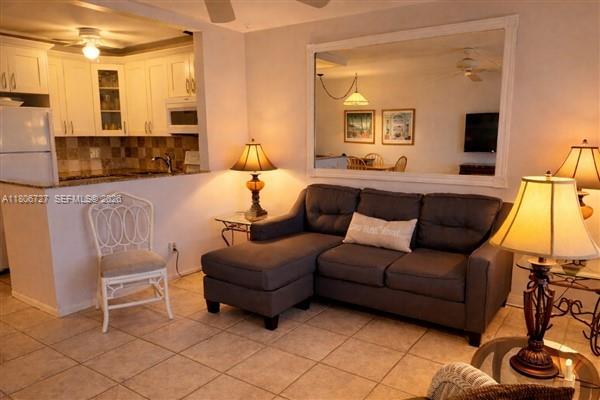 301 East McNab Road, Unit 205 Pompano Beach, FL 33060 - Photo 3 of 23 a living room with furniture and a large window