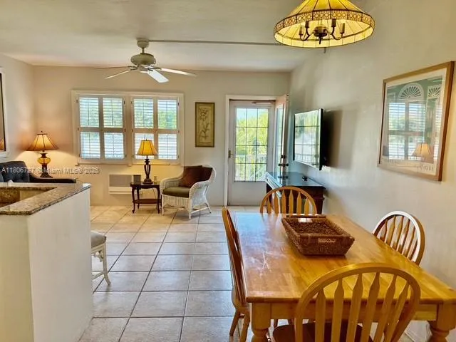 a living room with furniture a chandelier and a large window