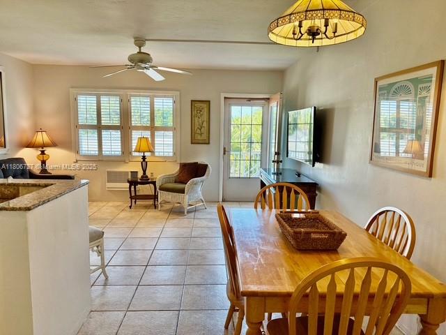 301 East McNab Road, Unit 205 Pompano Beach, FL 33060 - Photo 7 of 22 a living room with furniture a chandelier and a large window