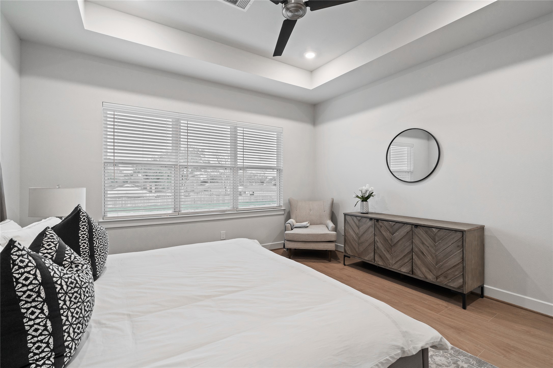 6445 Rena Street Houston, TX 77092 - Photo 21 of 33 Generously sized primary suite with clean wall lines and a wide rear window that brings in steady natural light, keeping the space open and relaxed without feeling crowded.