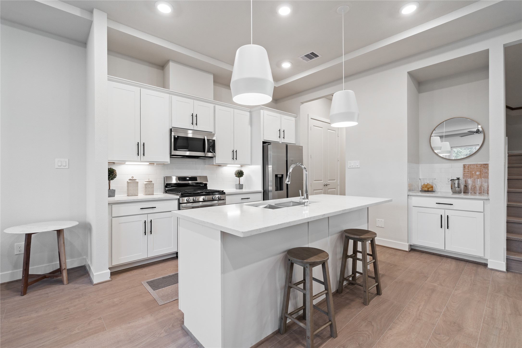 6445 Rena Street Houston, TX 77092 - Photo 7 of 33 Clean white cabinetry and stainless appliances keep the look bright and easy to maintain.