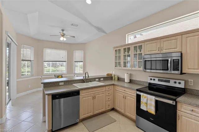 a kitchen with stainless steel appliances granite countertop a sink and stove top oven