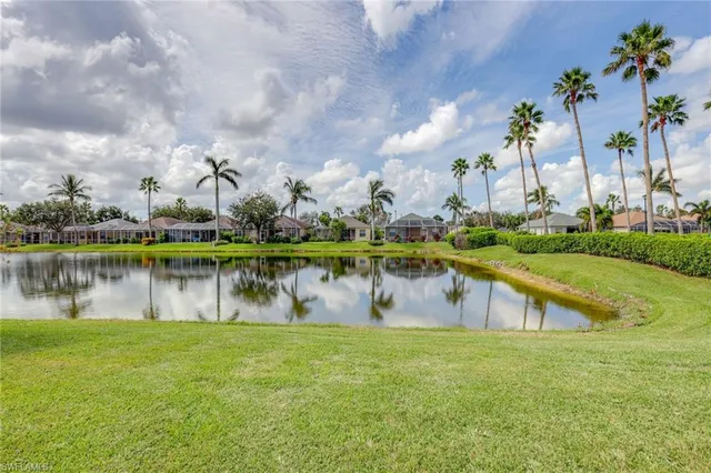 a view of a lake with a big yard and a large building view