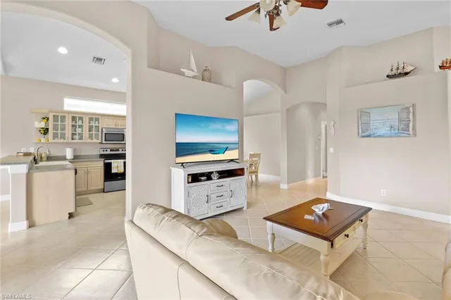 a kitchen with furniture a refrigerator and a stove