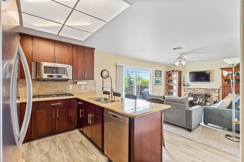 a kitchen with wooden cabinets and a stove top oven