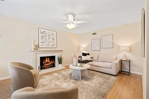 a view of a living room with a fireplace and a rug