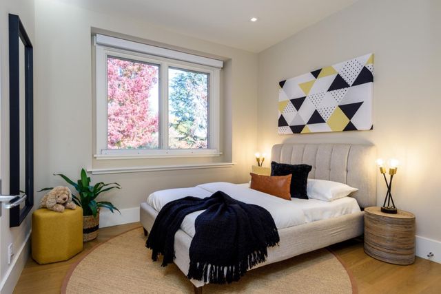 a living room with furniture a flat screen tv and a table