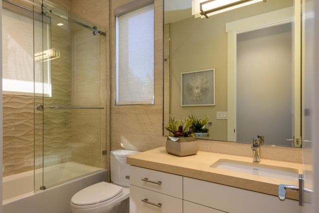 a bedroom with furniture and a large window