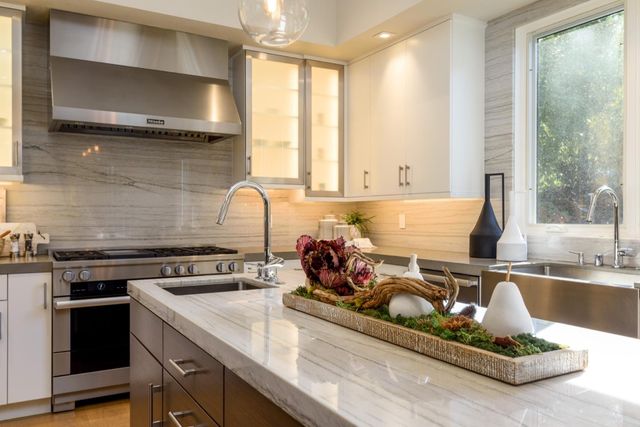 a living room with furniture a fireplace and a floor to ceiling window