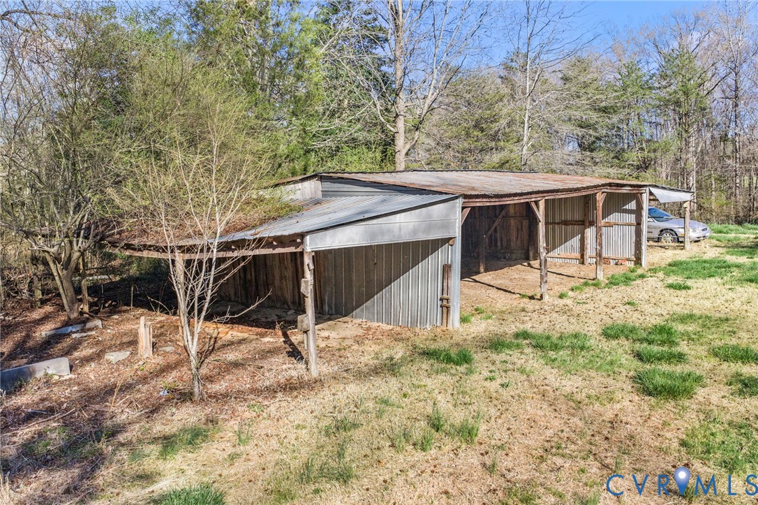 19161 Hollowing Creek Road Beaverdam, VA 23015 - Photo 11 of 27 a view of a backyard with wooden fence and large trees