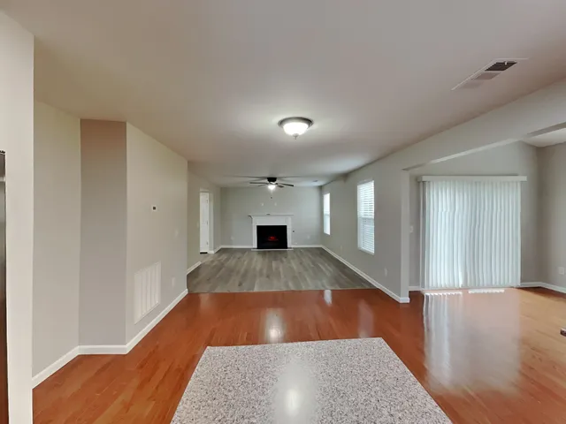 view of an empty room with wooden floor and a window