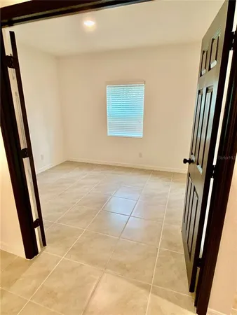 a view of an empty room with a window