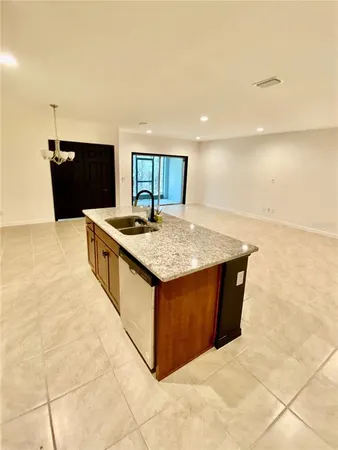 a kitchen with stainless steel appliances granite countertop a sink and a stove