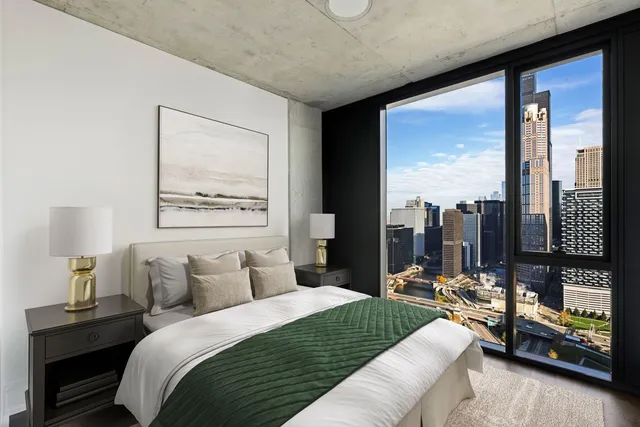 a bedroom with a large bed and a night stand