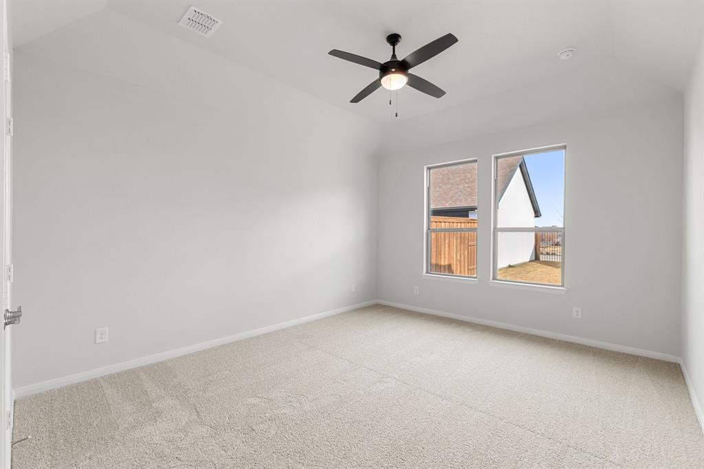 1847 Cole Road Van Alstyne, TX 75495 - Photo 9 of 26 an empty room with a window and a fan