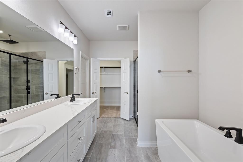 1847 Cole Road Van Alstyne, TX 75495 - Photo 10 of 26 a bathroom with a tub sink and mirror