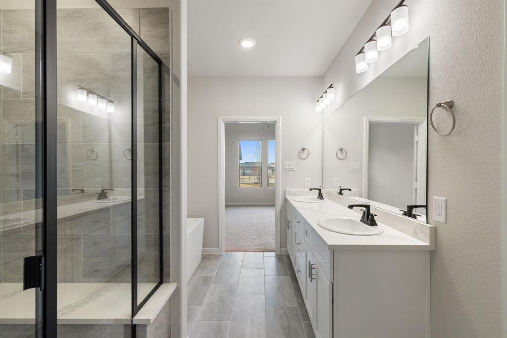 1847 Cole Road Van Alstyne, TX 75495 - Photo 11 of 26 a en suite bathroom with a sink a mirror and a shower