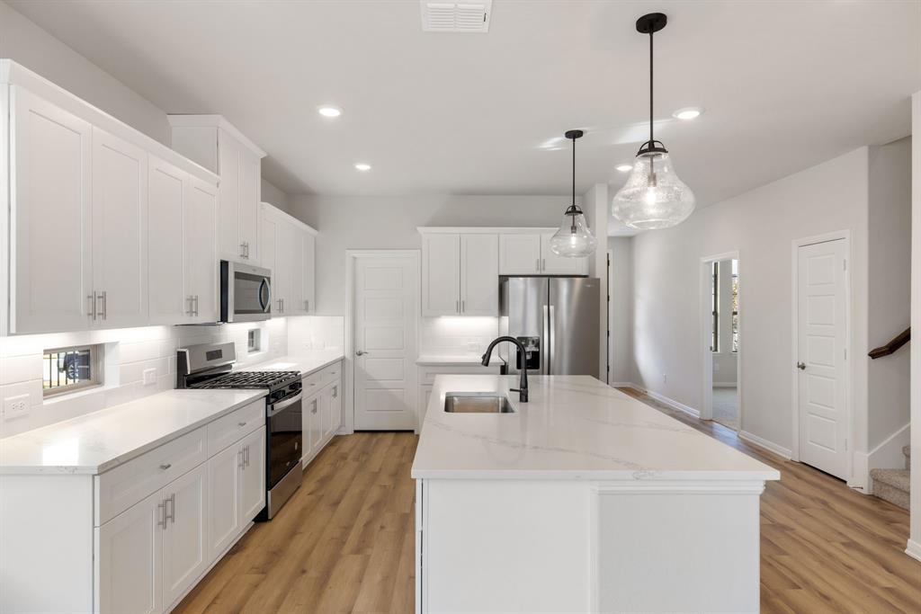 1847 Cole Road Van Alstyne, TX 75495 - Photo 5 of 26 a large white kitchen with a sink a refrigerator and a stove