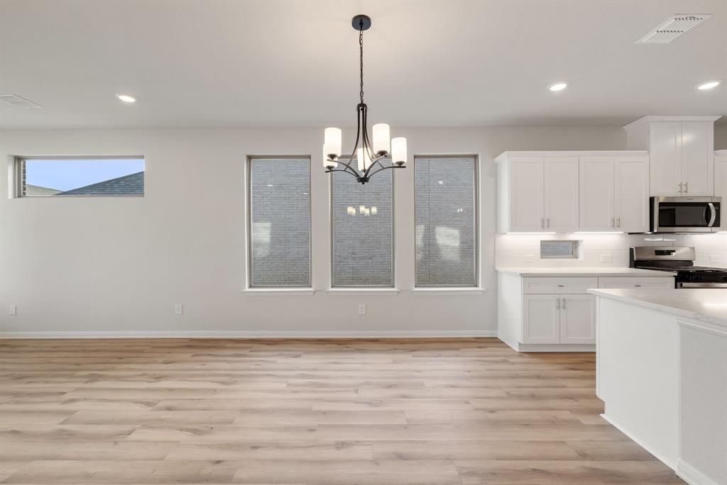 1847 Cole Road Van Alstyne, TX 75495 - Photo 7 of 26 a view of a kitchen with microwave and cabinets