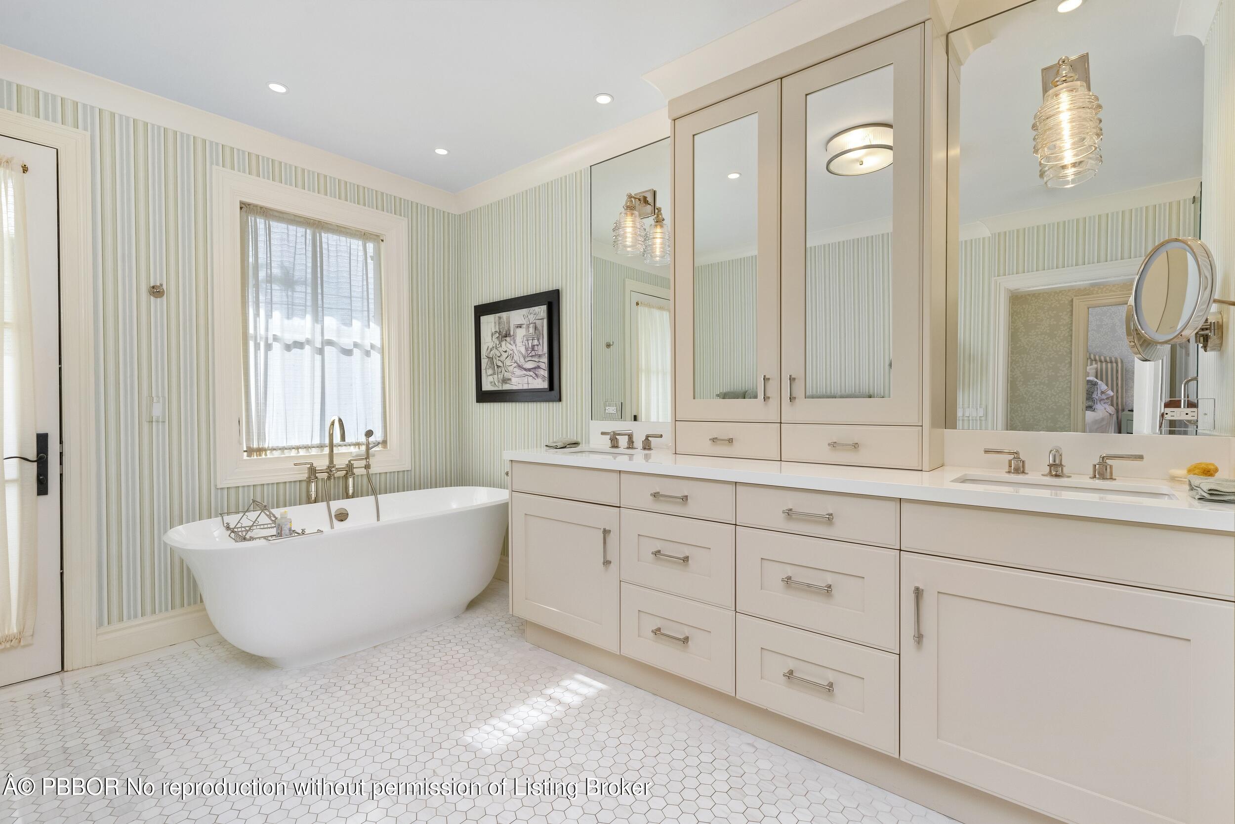 258 List Road Palm Beach, FL 33480 - Photo 26 of 45 a spacious bathroom with double vanity sinks a large mirror and a bathtub